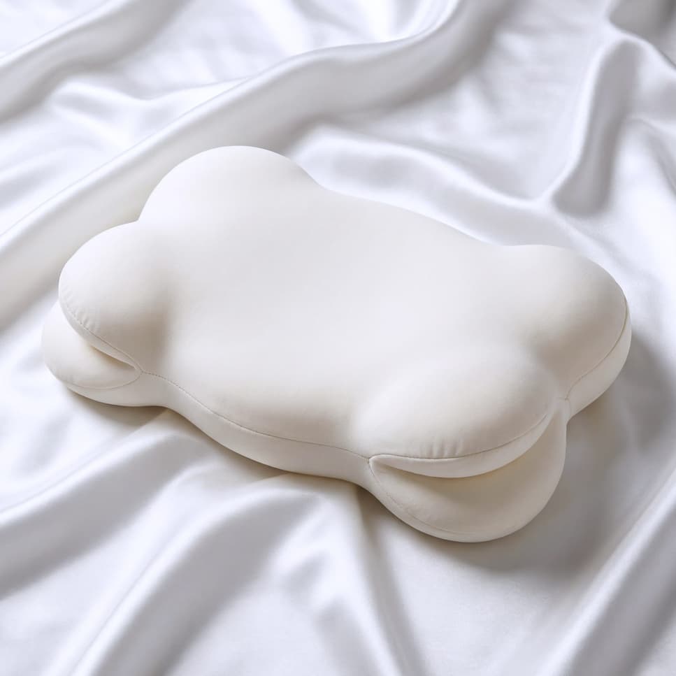 Cloud Pillow product photo on soft bedding