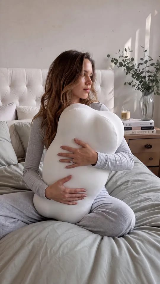 Sarah, founder of Lumuwala, holding the Cloud Pillow