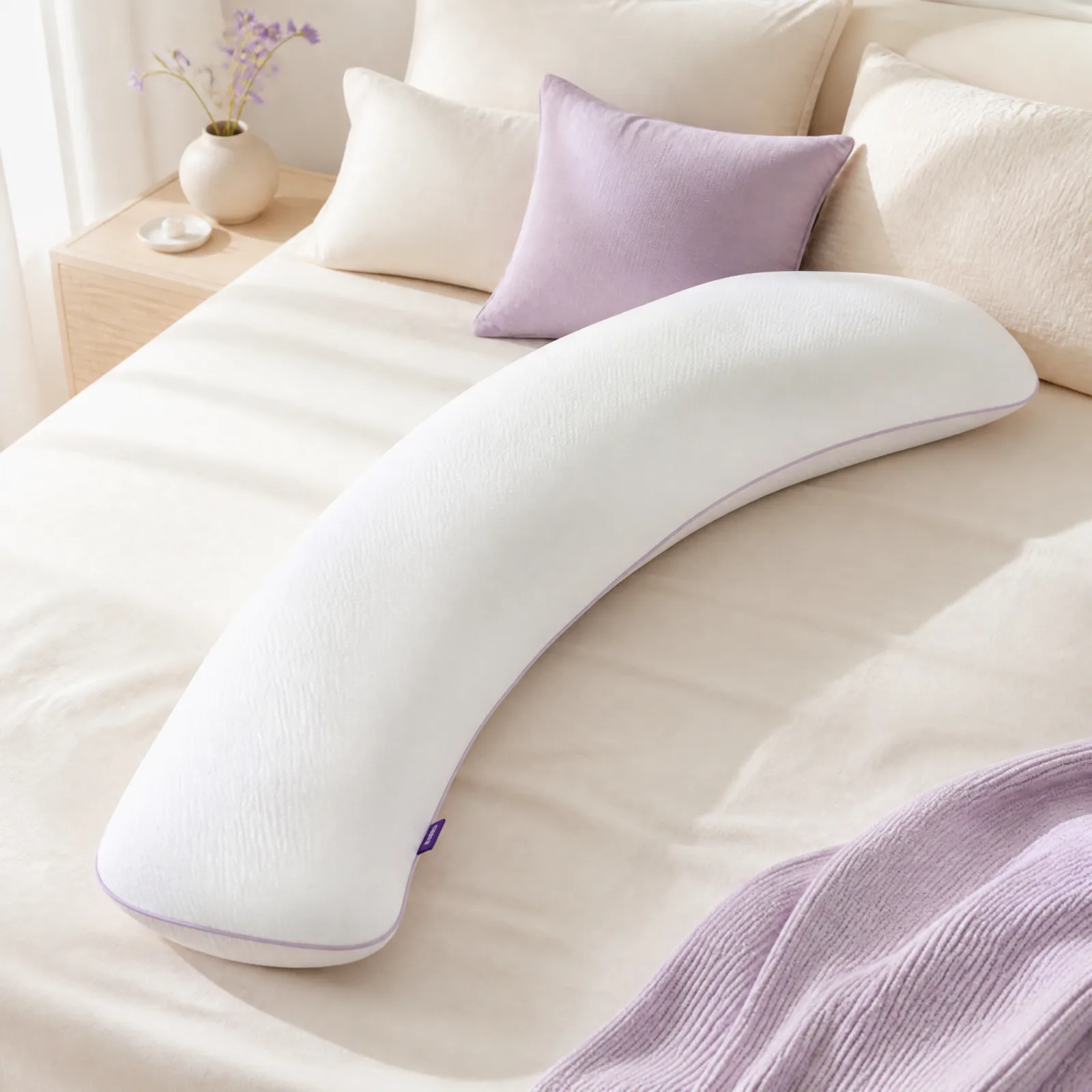 lumuwala hug pillow on cream bedding with lavender accents